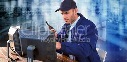 Composite image of focused security officer looking observing computer monitors and talking on walki