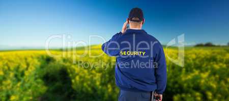Composite image of rear view of security officer listening to earpiece