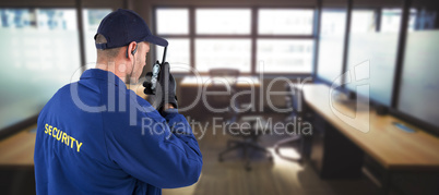 Composite image of rear view of focused security officer talking on walkie talkie