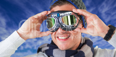 Composite image of happy man wearing aviator goggles