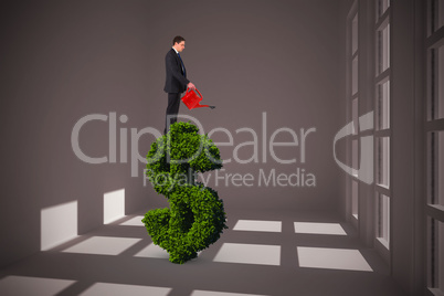 Composite image of businessman holding red watering can