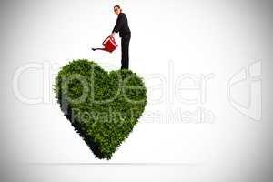 Composite image of businesswoman using red watering can