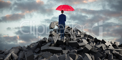 Composite image of full length rear view of businesswoman carrying red umbrella and briefcase