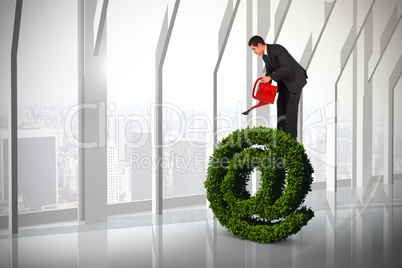 Composite image of businessman watering with red can