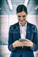 Composite image of smiling businesswoman using mobile phone