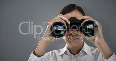 Composite image of close up of businesswoman looking through binoculars