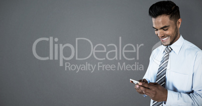 Composite image of smiling businessman using mobile phone