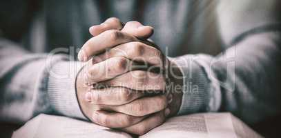 Close up of man with bible praying