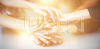 Group of business executives forming hand stack in office