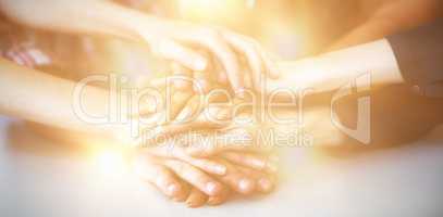 Group of business executives forming hand stack in office