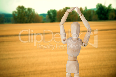 Composite image of wooden 3d figurine standing with hands raised