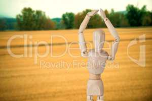 Composite image of wooden 3d figurine standing with hands raised