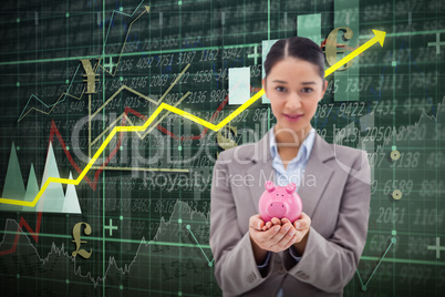 Composite image of portrait of a businesswoman holding a piggy bank
