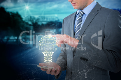 Composite image of businessman using mobile phone