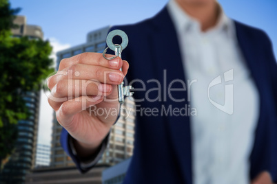 Composite image of mid section of businesswoman showing new house key