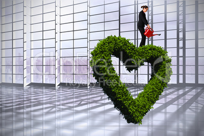 Composite image of businesswoman using red watering can