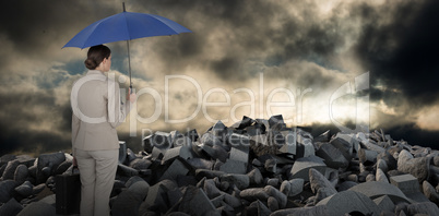 Composite image of businesswoman holding blue umbrella and a briefcase
