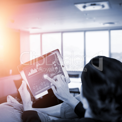 Composite image of businesswoman using digital tablet on white background