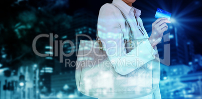 Composite image of mid section of woman holding credit card