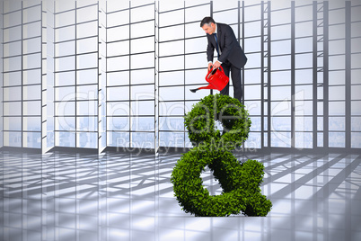 Composite image of mature businessman using watering can