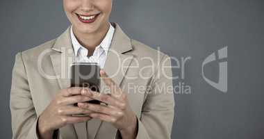 Composite image of close up of smiling businesswoman using mobile phone