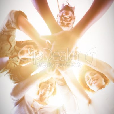 Directly below portrait of business people stacking hands