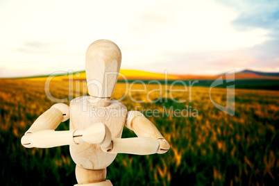 Composite image of close up of 3d wooden figurine kneeling with both hands joined
