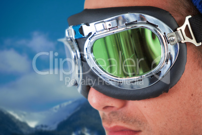 Composite image of close up of young man wearing aviator goggles