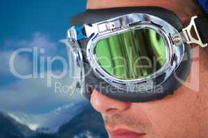 Composite image of close up of young man wearing aviator goggles