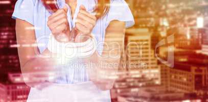 Composite image of mid section of businesswoman with tied hands