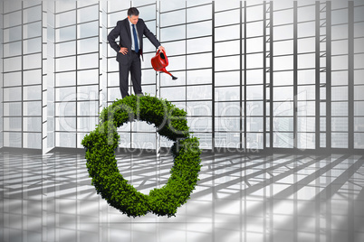 Composite image of mature businessman using watering can