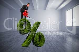 Composite image of businessman watering with red can