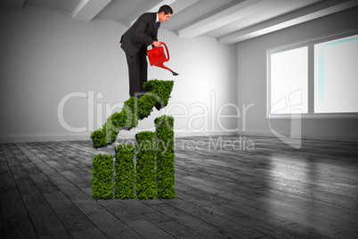 Composite image of businessman watering with red can