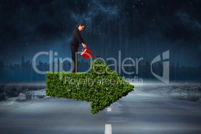 Composite image of businesswoman using red watering can