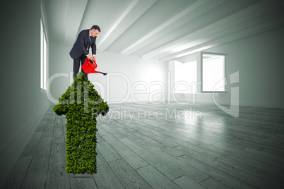 Composite image of mature businessman using watering can