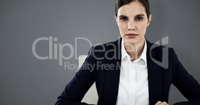 Composite image of portrait of businesswoman typing on keyboard at desk