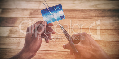 Businessman cutting credit card with scissors