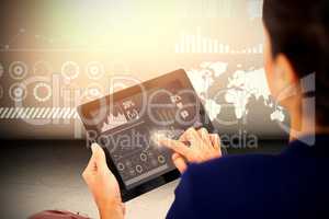 Composite image of businesswoman working on digital tablet over white background