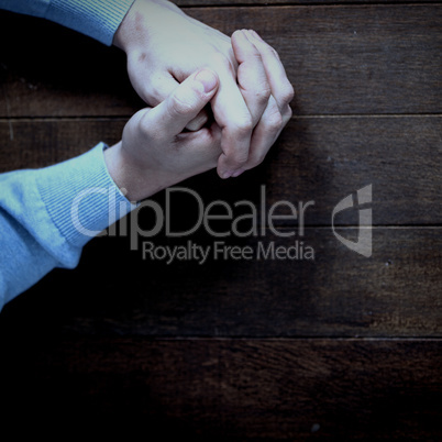 Man praying on wooden table