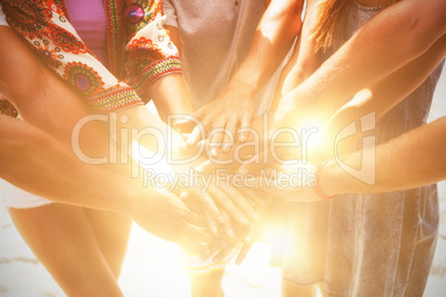 Midsection of friends stacking hands