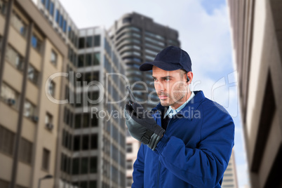 Composite image of serious security officer talking on walkie talkie