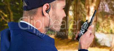 Composite image of close up of security officer talking on walkie talkie