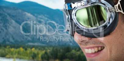 Composite image of close up of happy man wearing aviator goggles