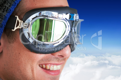 Composite image of close up of smiling man wearing aviator goggles