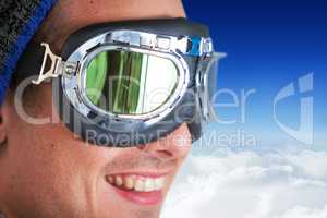 Composite image of close up of smiling man wearing aviator goggles