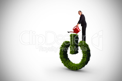 Composite image of businesswoman using red watering can