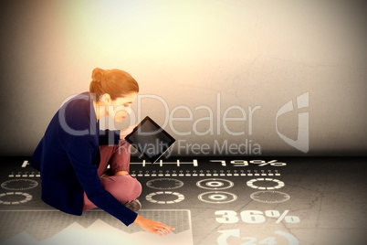 Composite image of businesswoman holding digital tablet on white background