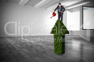 Composite image of mature businessman using watering can