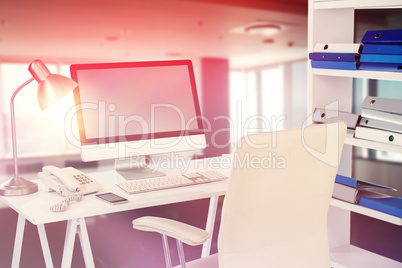 Composite image of computer with telephone and mobile phone at desk