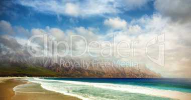 Idyllic view of sea by mountains